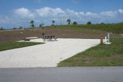 Photo: 030, Campsite with picnic table, grill and fire ring on the left and water and electric on the left.