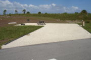 Photo: 030, Campsite with picnic table, grill and fire ring on the left and water and electric on the left.
