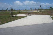 Photo: 031, Campsite with picnic table, grill and fire ring on the left and water and electric on the left.
