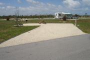 Photo: 033, Campsite with picnic table, grill and fire ring on the left and water and electric on the left.