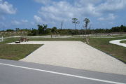 Photo: 034, Campsite with picnic table, grill and fire ring on the left and water and electric on the left.