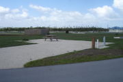 Photo: 035, Campsite with picnic table, grill and fire ring on the left and water and electric on the left.