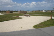 Photo: 037, Campsite with picnic table, grill and fire ring on the left and water and electric on the left.