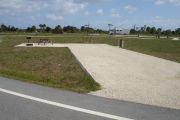 Photo: 040, Campsite with picnic table, grill and fire ring on the left and water and electric on the left.