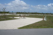 Photo: 041, Campsite with picnic table, grill and fire ring on the left and water and electric on the left. A restroom is nearby.