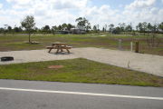 Photo: 046, Campsite with picnic table, grill and fire ring on the left and water and electric on the left.