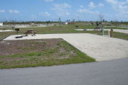 Photo: 047, Campsite with picnic table, grill and fire ring on the left and water and electric on the left. A restroom is nearby.