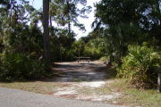 Picnic table and clothes posts at rear of site surrounded by trees.
