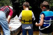 Paddlers prepare to enter the water in a canoe at Lake Griffin State Park.