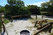 Photo: 001, Looking from the East across the campsite, the Ocean shoreline is on the left. The picnic table and fire ring is on the site. The water and electrical services are on the far side of the site, between this and the next site. A Park truck is on the camp road to the right.