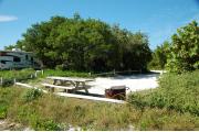 Photo: 027, From the ocean side the fire ring and picnic table are to the front. The water and electrical services are to the left between the sites. A motor home is on the site to the left.