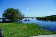 Father and sons in a rented kayak going on fishing adventure on Upper Myakka Lake.