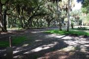 This is a picture of campsite 2 from the back of the site looking toward the road.   The site has water and 50amp electric service.  This is a partly sunny site with a gravel foundation.  The site has a picnic table and a ground campfire ring.