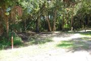 Campsite 4 is a partial sunny site with a gravel foundation located on the right hand side of the road.  Looking into the site on the right is the water and 50amp electrical service. There is a picnic table and ground campfire ring.  At the front left side of the site is the brown site marker.