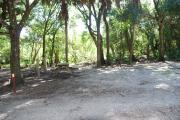 Campsite 7 is a partial sunny site with a gravel foundation located on the right hand side of the road.  Looking into the site on the right is the water and 50amp electrical service. There is a picnic table and ground campfire ring.  At the front left side of the site is the brown site marker.