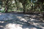 This is a picture of campsite 7 from the back of the site looking toward the road.   The site has water and 50amp electric service.  This is a partly sunny site with a gravel foundation.  The site has a picnic table and a ground campfire ring.