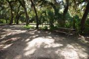 This is a picture of campsite 17 from the back of the site looking toward the road.   The site has water and 50amp electric service.  This is a partly sunny site with a gravel foundation.  The site has a picnic table and a ground campfire ring.