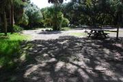 This is a picture of campsite 21 from the back of the site looking toward the road.   The site has water and 50amp electric service.  This is a partly sunny site with a gravel foundation.  The site has a picnic table and a ground campfire ring.