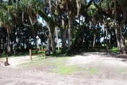 Campsite 22 is a partial sunny site with a gravel foundation located on the right hand side of the road.  Looking into the site on the right is the water and 50amp electrical service. There is a picnic table and ground campfire ring.  At the front left side of the site is the brown site marker.