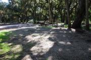 This is a picture of campsite 23 from the back of the site looking toward the road.   The site has water and 50amp electric service.  This is a partly sunny tent only site with a gravel foundation.  The site has a picnic table and a ground campfire ring.