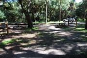 This is a picture of campsite 25 from the back of the site looking toward the road.   The site has water and 50amp electric service.  This is a shady tent only site with a gravel foundation.  The site has a picnic table and a ground campfire ring.