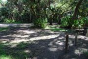 This is a picture of campsite 26 from the back of the site looking toward the road.   The site has water and 50amp electric service.  This is a shady tent only site with a gravel foundation.  The site has a picnic table and a ground campfire ring.