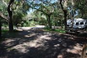 This is a picture of campsite 30 from the back of the site looking toward the road.   The site has water and 50amp electric service.  This is a partly sunny site with a gravel foundation.  The site has a picnic table and a ground campfire ring.