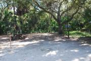 This is a picture of campsite 32 looking from the road into the partly sunny site.  This site has 50amp service and water hookups.  There is a gravel foundation with a picnic table and a ground campfire ring.