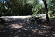 This is a picture of campsite 33 from the back of the site looking toward the road.   The site has water and 50amp electric service.  This is a partly sunny site with a gravel foundation.  The site has a picnic table and a ground campfire ring.
