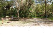 This is a picture of campsite 35 looking from the road into the partly sunny site.  This site has 50amp service and water hookups.  There is a gravel foundation with a picnic table and a ground campfire ring.