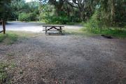 This is a picture of campsite 37 from the back of the site looking toward the road.   The site has water and 50amp electric service.  This is a partly sunny site with a gravel foundation.  The site has a picnic table and a ground campfire ring.