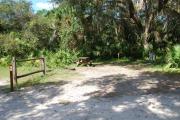 Campsite 39 is a sunny site with a gravel foundation located on the right hand side of the road.  Looking into the site on the right is the water and 50amp electrical service. There is a picnic table and ground campfire ring.  At the front left side of the site is the brown site marker.