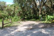 This is a picture of campsite 39 looking from the road into the sunny site.  This site has 50amp service and water hookups.  There is a gravel foundation with a picnic table and a ground campfire ring.
