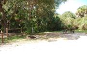 This is a picture of campsite 40 looking from the road into the sunny site.  This site has 50amp service and water hookups.  There is a gravel foundation with a picnic table and a ground campfire ring.
