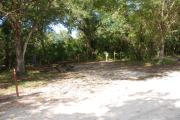 Campsite 43 is a partial sunny site with a gravel foundation located on the right hand side of the road.  Looking into the site on the right is the water and 50amp electrical service. There is a picnic table and ground campfire ring.  At the front left side of the site is the brown site marker.