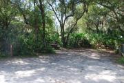 Campsite 48 is a partial sunny site with a gravel foundation located on the right hand side of the road.  Looking into the site on the right is the water and 50amp electrical service. There is a picnic table and ground campfire ring.  At the front left side of the site is the brown site marker.
