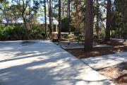 A canopy of towering long-leaf pine trees hover over islands of sparse native vegetation between this spot and Site 25.  Amenities include water/electric, picnic tables, campfire ring and clothes line.