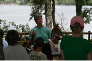 A park volunteer delivers an interpretive program on wildlife along the high banks of Fred Gannon Rocky Bayou State Park.