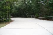 30 foot back in site surrounded by beautiful trees and split rail fencing with concrete pad.
