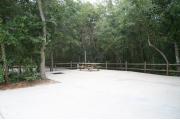 30 foot back in site surrounded by beautiful trees and split rail fencing and concrete pad.