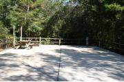 30 foot back in site surrounded by beautiful trees and split rail fencing with concrete pad.