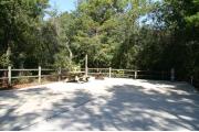 30 foot back in site surrounded by beautiful trees and split rail fencing with concrete pad.