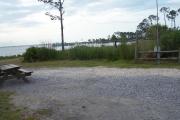 A lagoon view bordering the north side of the site with a picnic table and fire ring near the waters edge for those campfires on the lagoon.