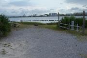 This large campsite offers gravel for the ground surface, grass on both sides and a spectacular Grand Lagoon view.