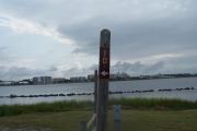 Sign post ten is located to the right. Sign post connect to another post with a clothes line tied between them. Electrical post and water spigot are located to the right of the post.