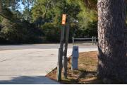 Sign post seventeen is located to the right. Sign post connect to another post with a clothes line tied between them. Electrical post and water spigot are located to the right of the post.