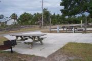 This ADA accessible site is paved with concrete and has an accessible grill and picnic table.