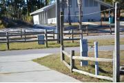 Sign post twenty is located to the right. Sign post connect to another post with a clothes line tied between them. Electrical post and water spigot are located just to the right of the post.