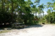 View from the right showing picnic table and ground grill.