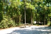 View from the right showing picnic table and ground grill.